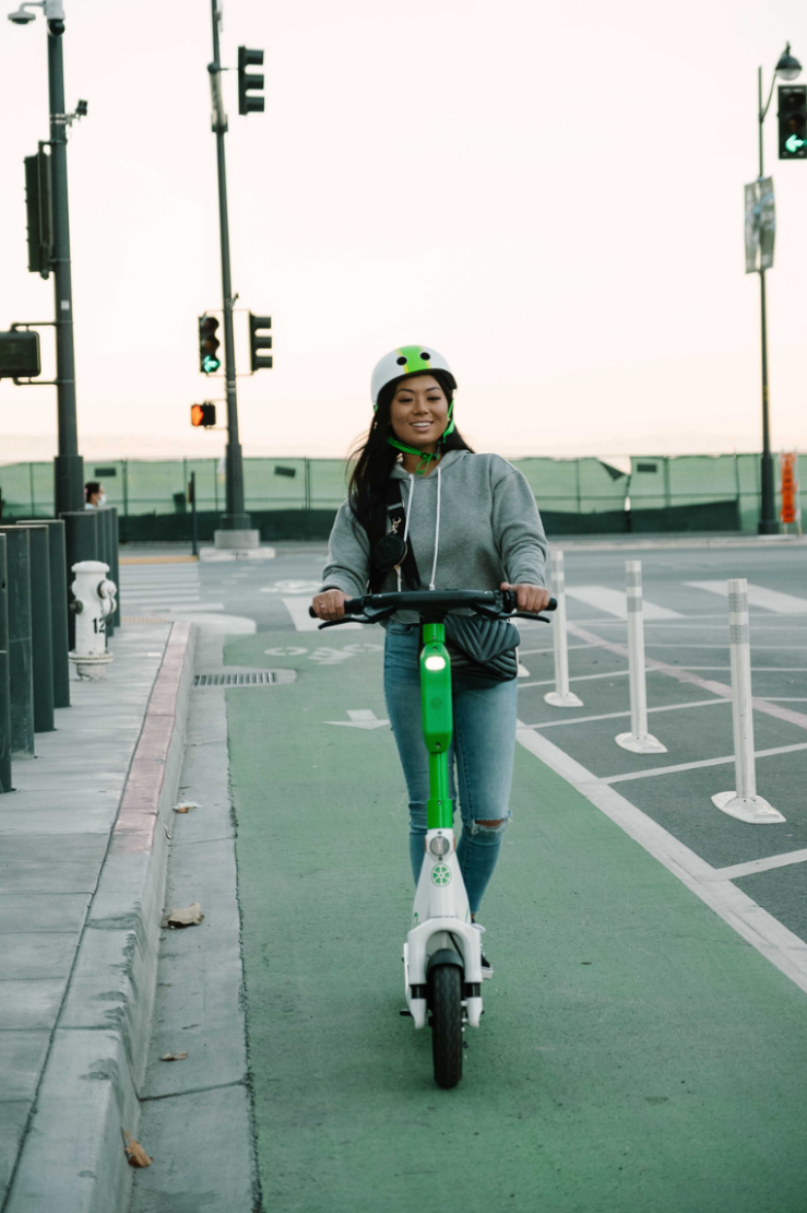image of person riding a Lime e-scooter