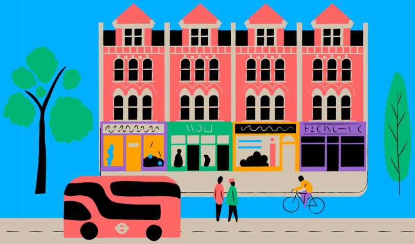 high street with people, a cyclist, and a red bus
